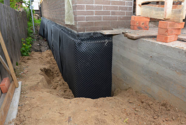 SJ Waterproofing Pros technician performing targeted Wet Basement Repair assessment in Fayetteville, GA